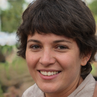 Woman with short brown hair smiling outdoors